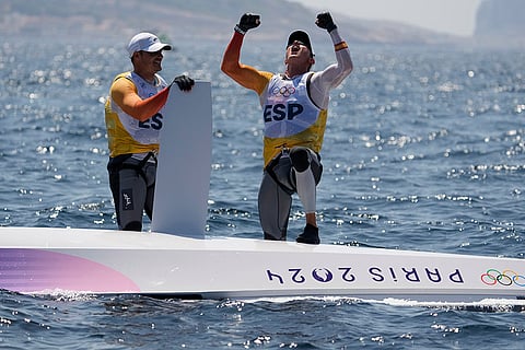 Florian Trittel Paul and Diego Botin Le Chever celebrate clinching the gold medal in the men's skiff race